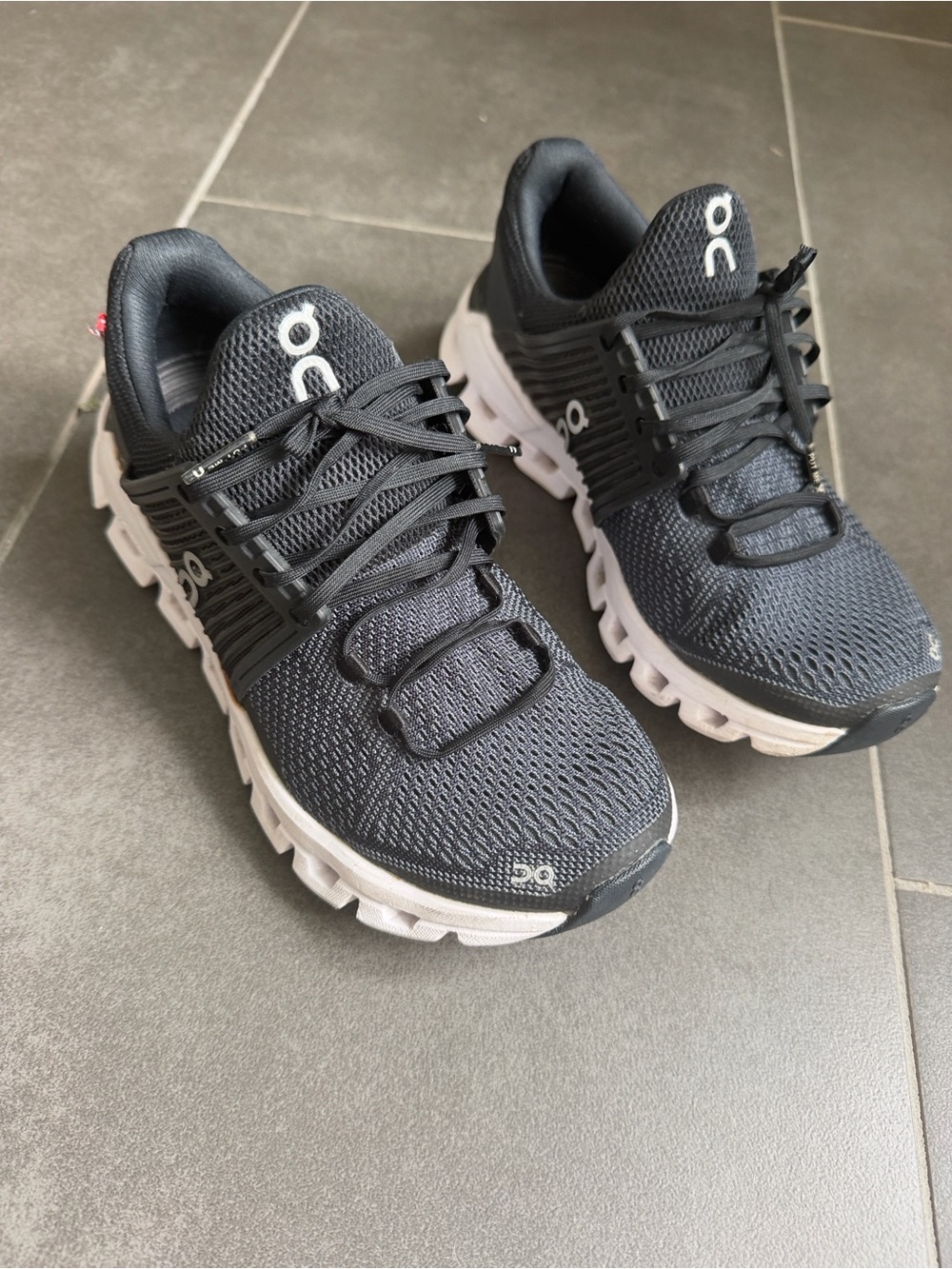 On Running women’s Athletic Shoe in Black with White Sole